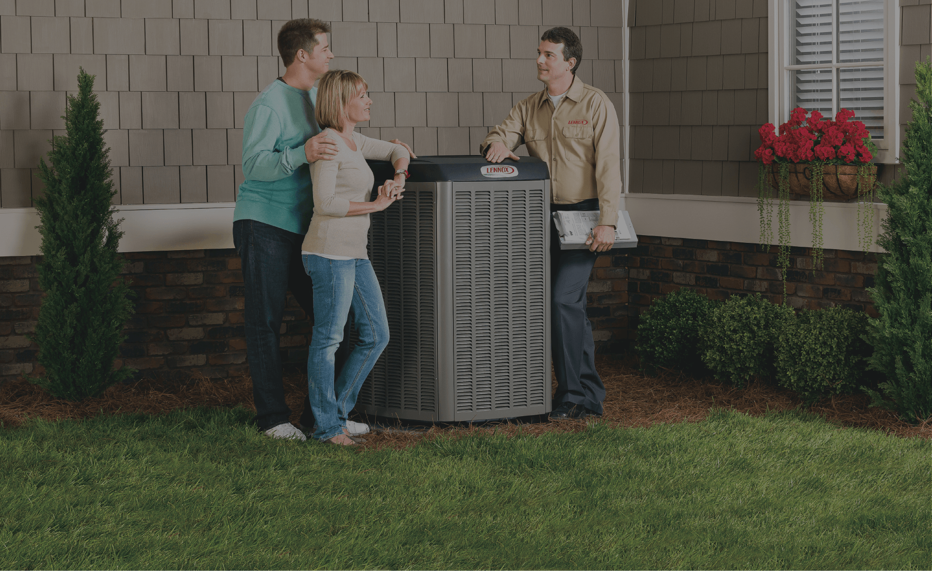 Image of a couple talking to a Lennox technician next to their HVAC