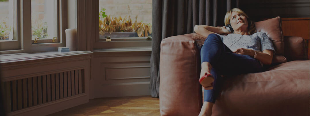 Image of a woman sitting comfortably on a couch