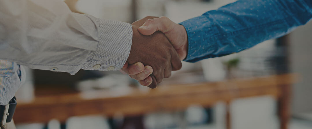 Image of two men shaking hands