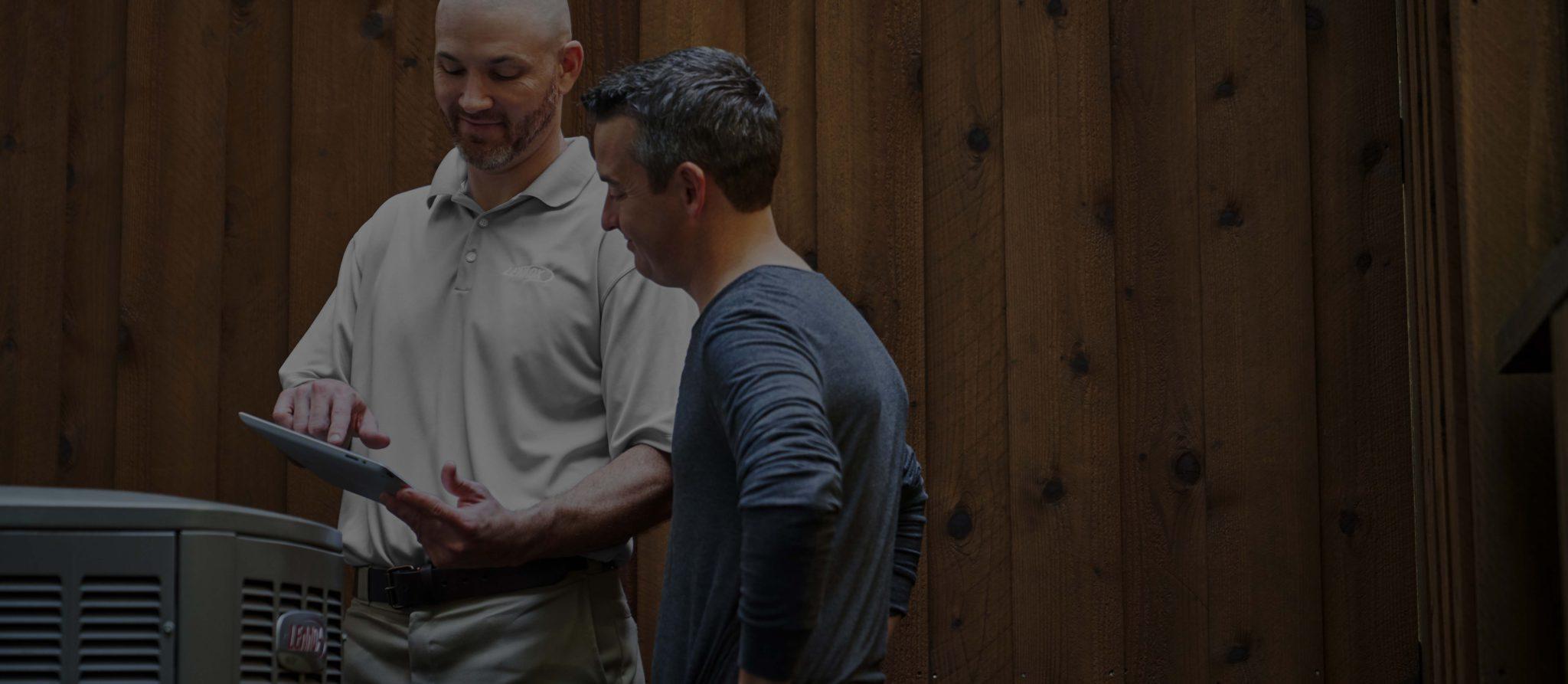 Image of a Lennox technician assisting a customer with a tablet.